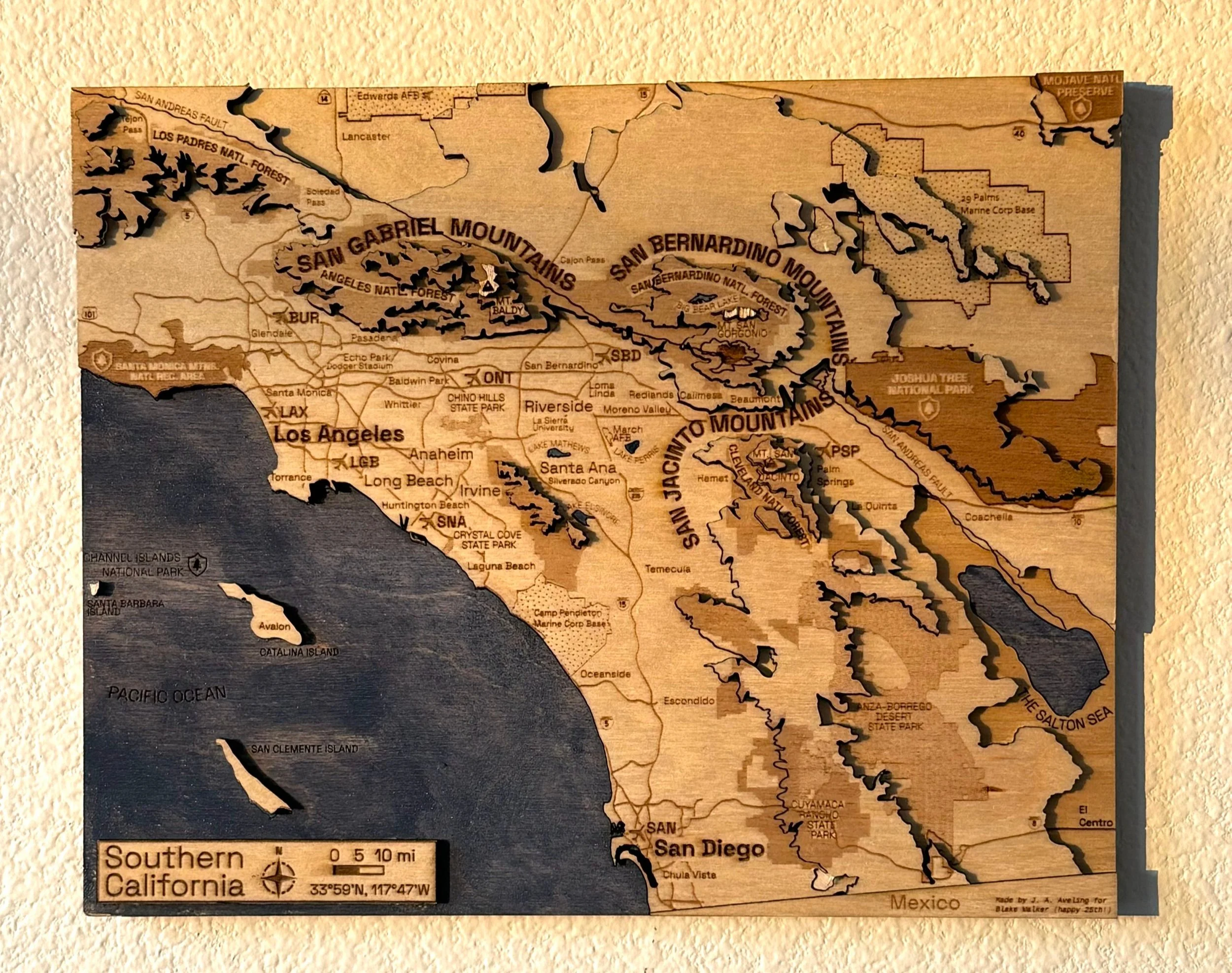 The same Southern California map from a slightly different angle, showing the dimensional quality of the mountain layers and the engraved regional details including Joshua Tree National Park in the northeast corner and Mexico at the southern border.